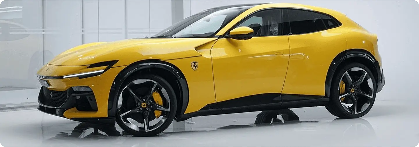 Yellow Ferrari Purosangue in a bright automotive workshop.