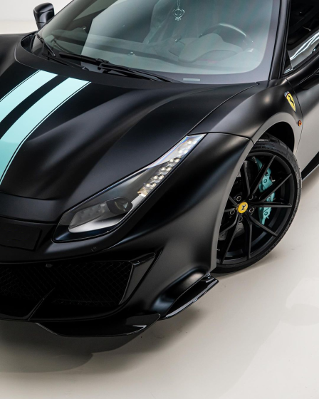 Black Ferrari Pista with turquoise stripes and wheel accents