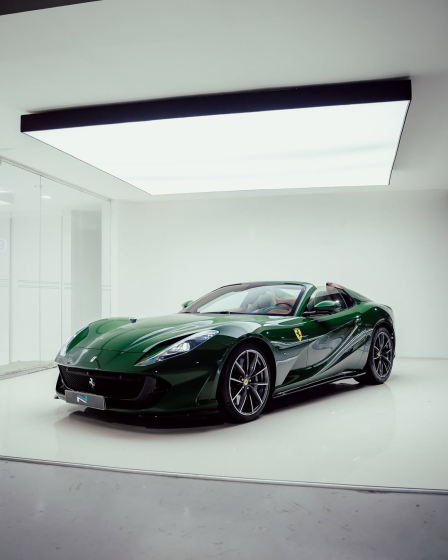 Green Ferrari photographed from the front in a white application studio