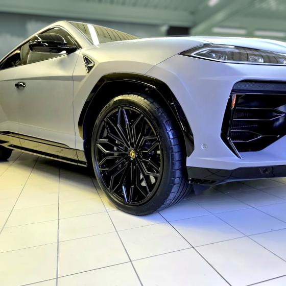 Close-up of a black alloy wheel on a silver Lamborghini Urus